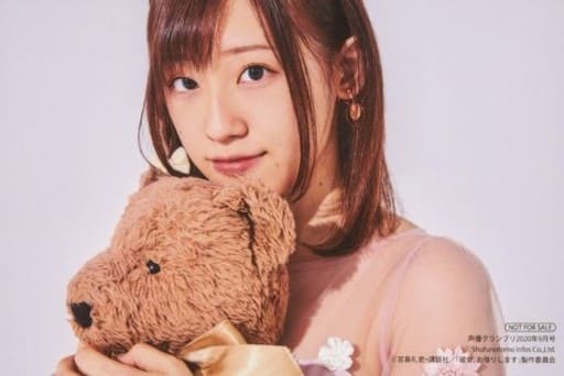 Takahashi Rie dressed in a flower dress with translucent sleeves, holding a teddy bear