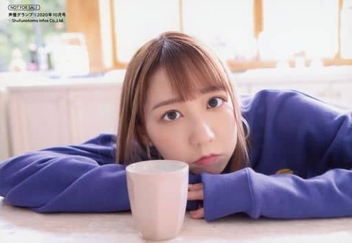 Natsukawa Shiina in a purple sweater, resting her chin on a table with a white mug