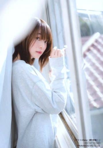 Ueda Reina in a white dress hiding behind white curtains putting her hands against the white window