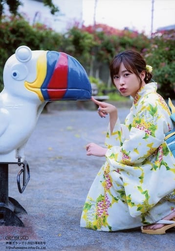 Minase Inori wearing a yukata squatting by a playground ride, playfully putting her finger on its beak and pouting back